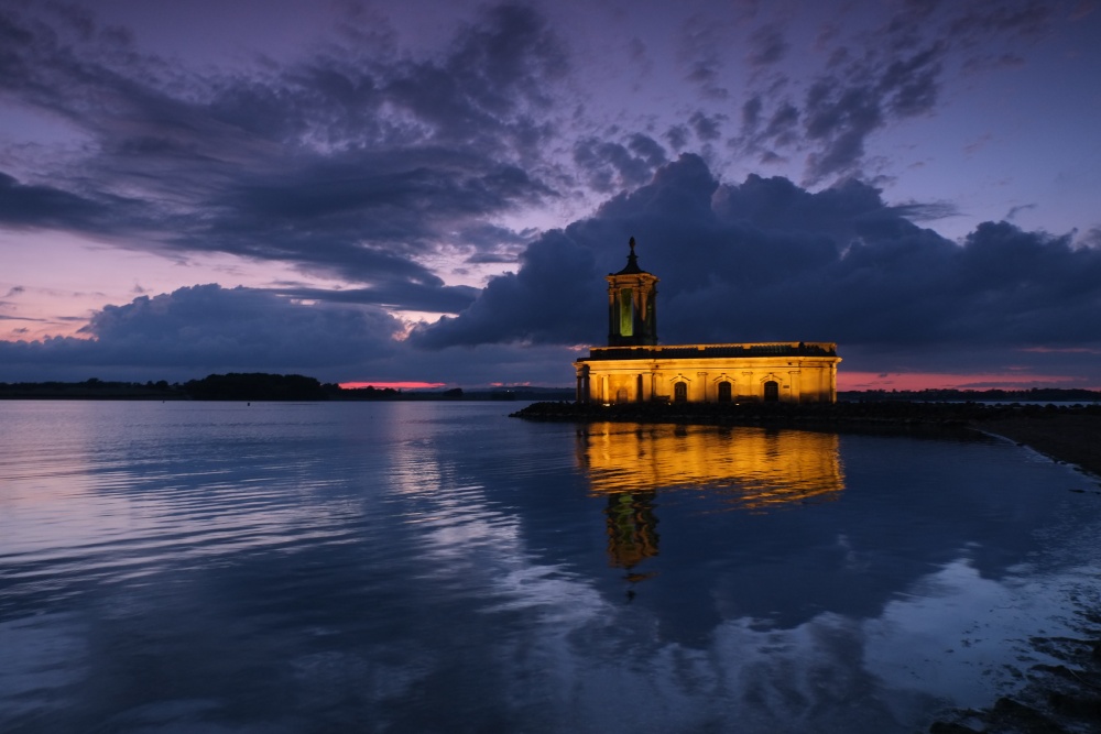 Photograph of The Normanton Church illuminated at night.
