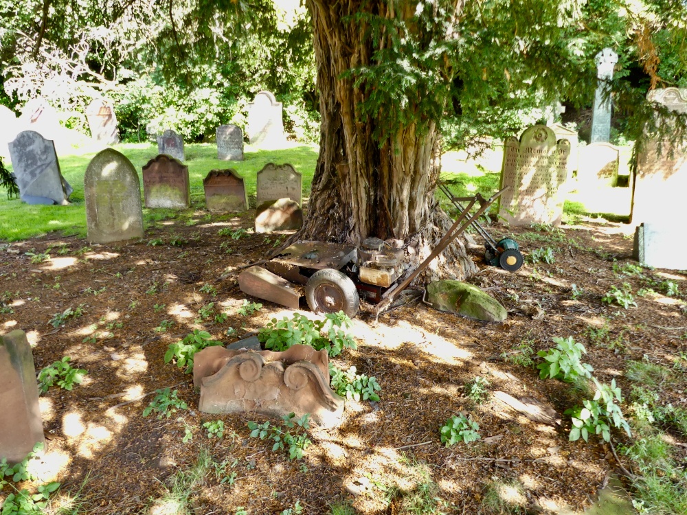 A LAWNMOWERS LAST RESTING PLACE,ST OSWALD CHURCHYARD,KIRKOSWALD,CUMBRIA.