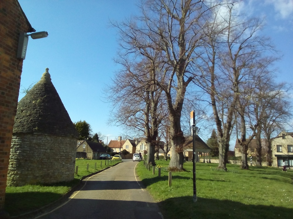 Village Green at Harrold, Beds. The village keep is the round building on the left.