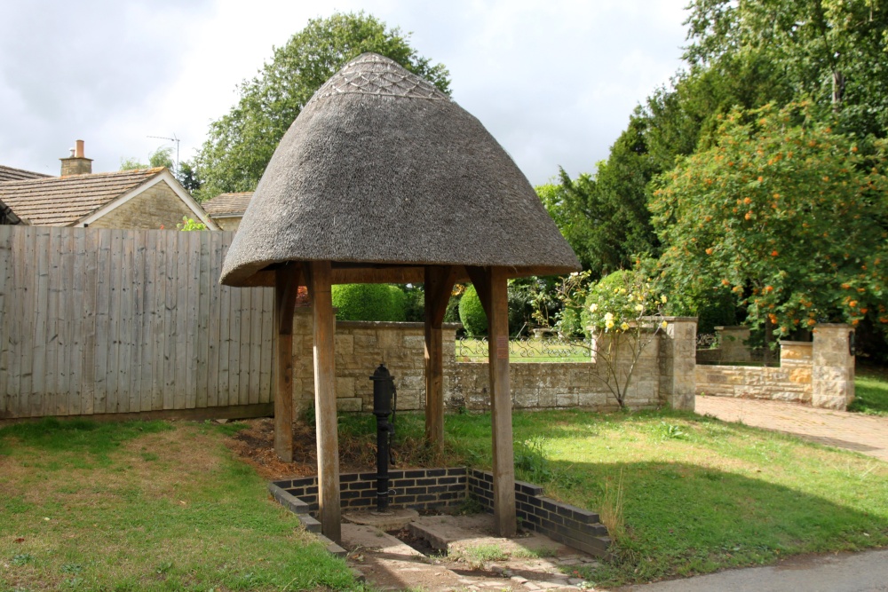 An attractive thatch-roofed pump in Main Street, Fringford
