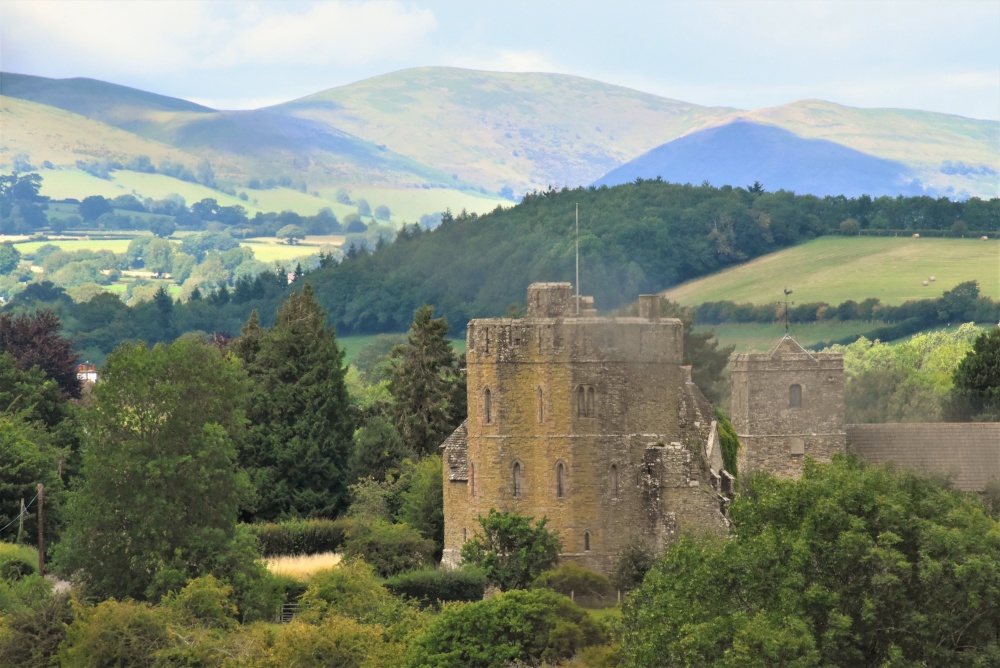 Photograph of Stokesay Castle with the Long Mynd in the background.